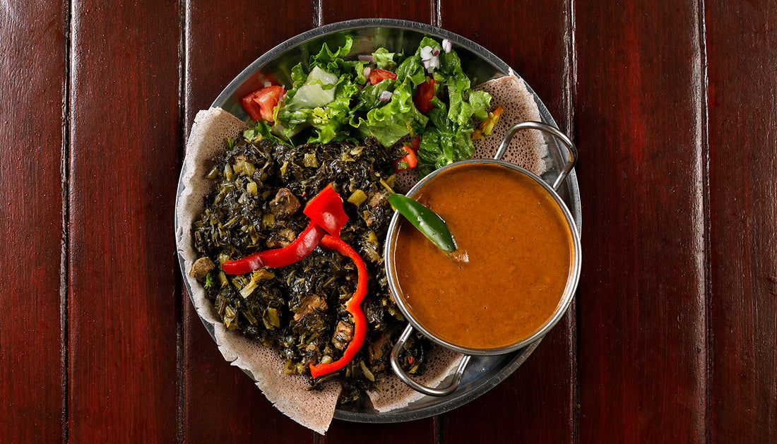 Gomen (Ethiopian Collard Greens), served with shiro over injera