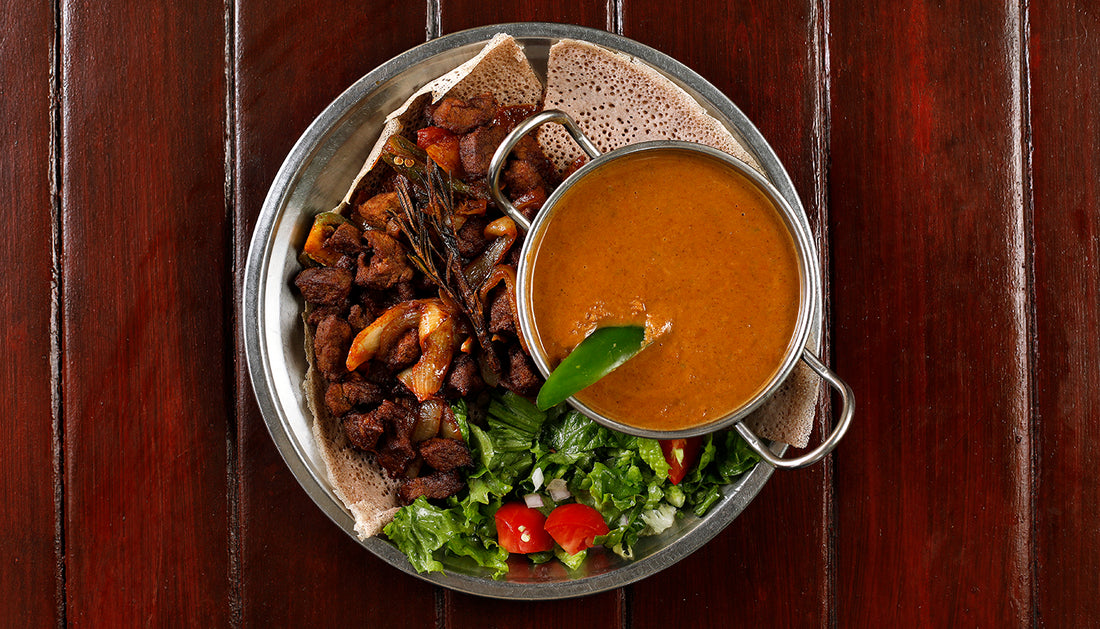 Spicy Sega Tibs served with Shiro Mitten and EThiopian salad on Injera