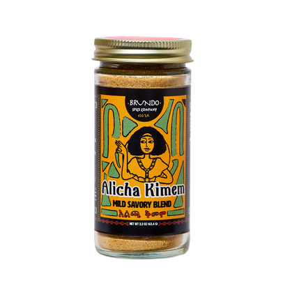 Brundo Spice Company Alicha Kimem Mild Savory Blend jar surrounded by garlic, ginger, and spices