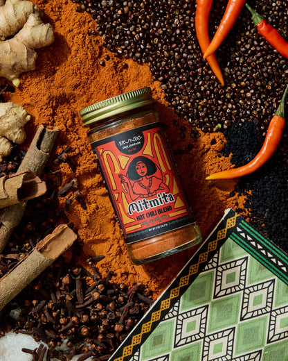Brundo Spice Company Mimita Hot Chili Blend in a glass spice jar with a gold lid on a white background.